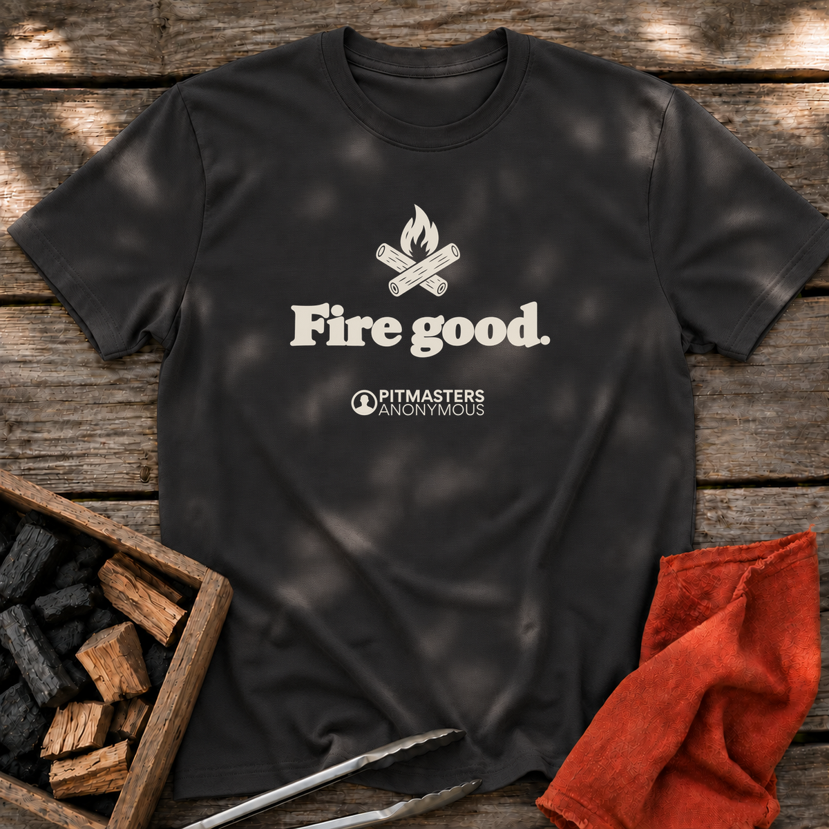 Black T-shirt with the design “Fire good.” printed on the front.