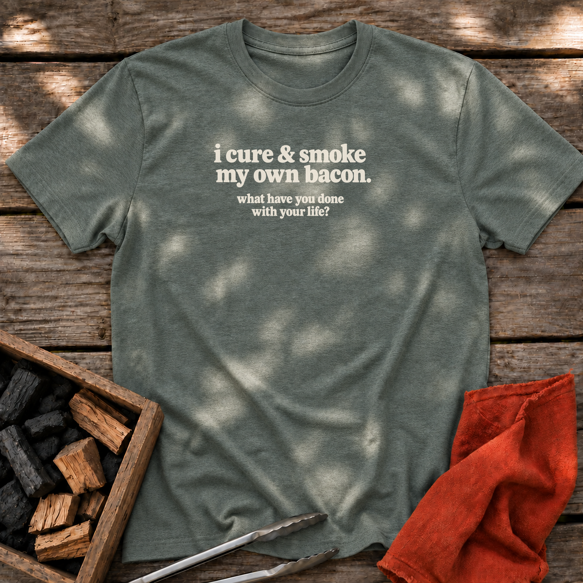 Heather Military Green T-shirt with the design “i cure & smoke my own bacon. what have you done with your life?” printed on the front.