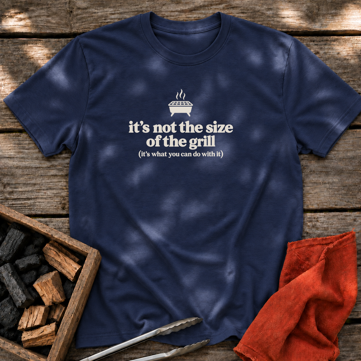 Navy T-shirt with the design “it's not the size of the grill (it's what you can do with it)” printed on the front.
