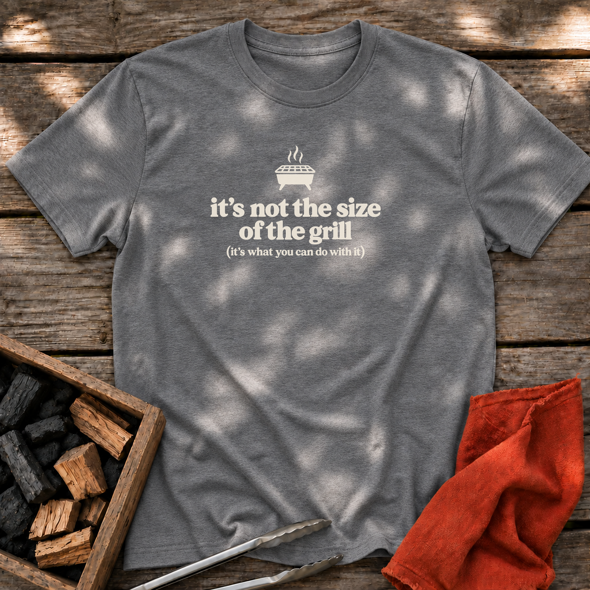 Graphite Heather T-shirt with the design “it's not the size of the grill (it's what you can do with it)” printed on the front.