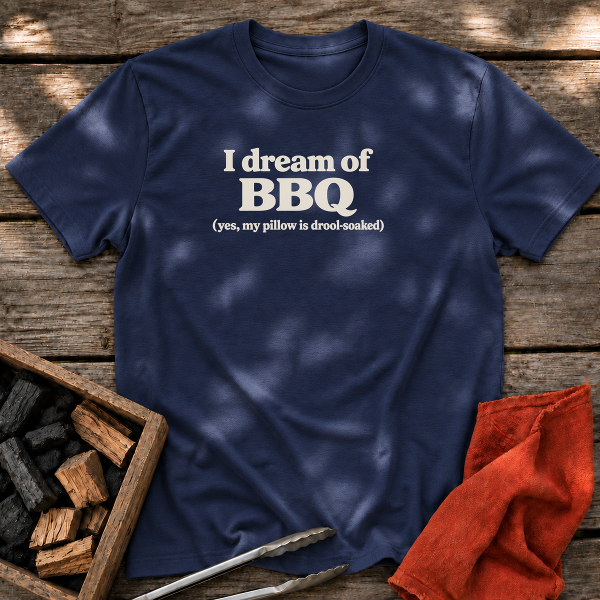 Navy T-shirt with the design “I dream of BBQ (yes, my pillow is drool-soaked)” printed on the front.