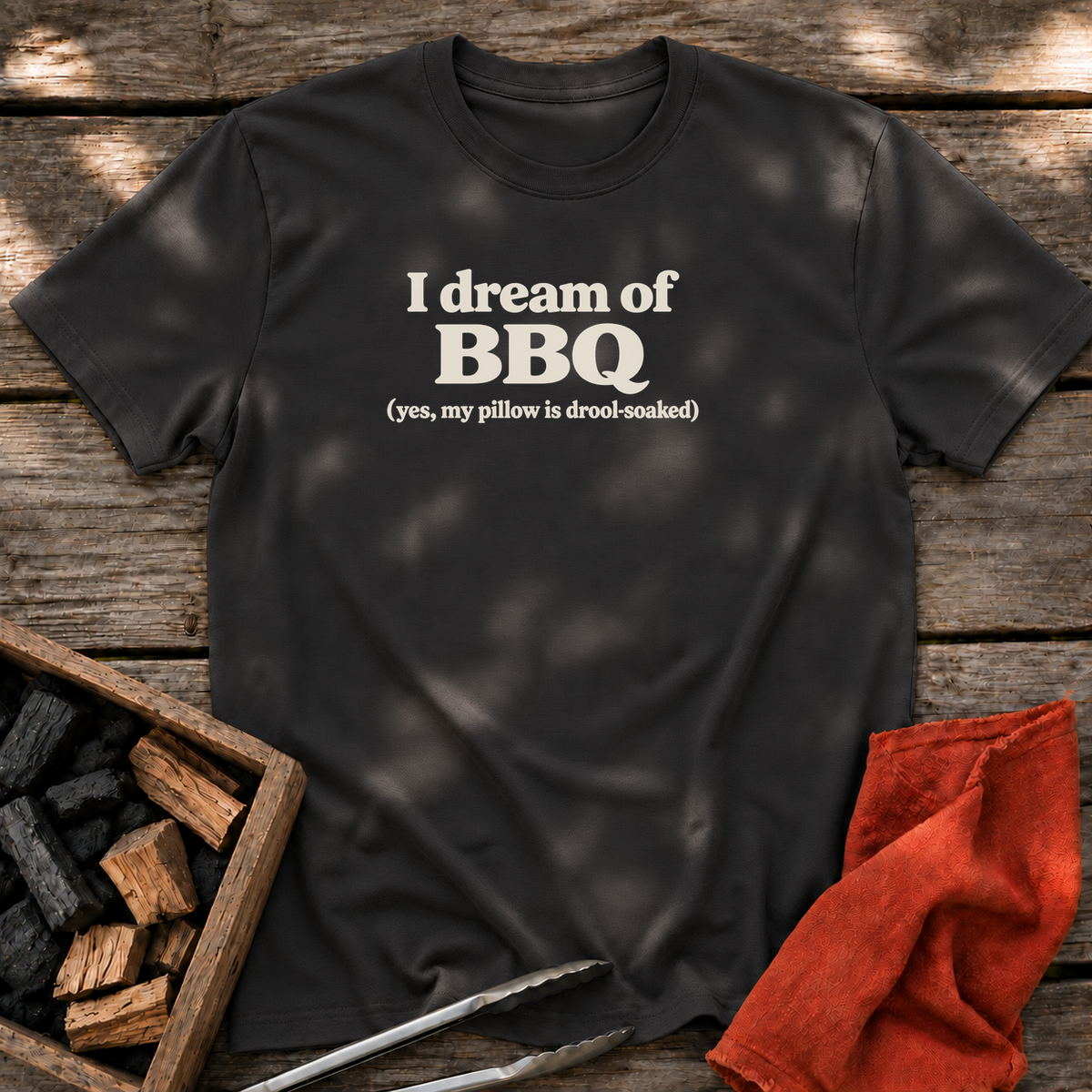 Black T-shirt with the design “I dream of BBQ (yes, my pillow is drool-soaked)” printed on the front.