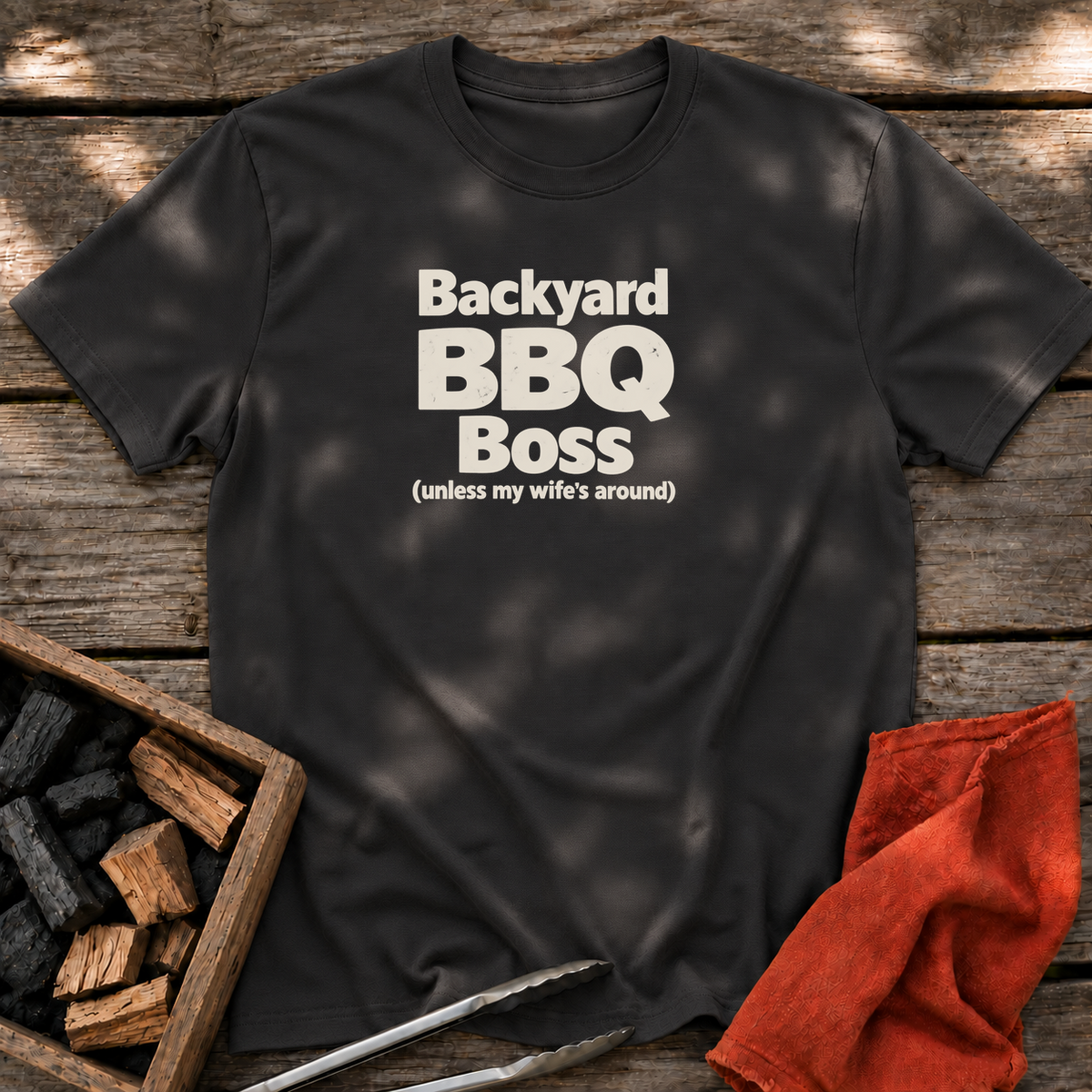 Black T-shirt with the design “Backyard BBQ Boss (unless my wife's around)” printed on the front.