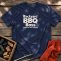 Navy T-shirt with the design “Backyard BBQ Boss (unless my wife's around)” printed on the front.