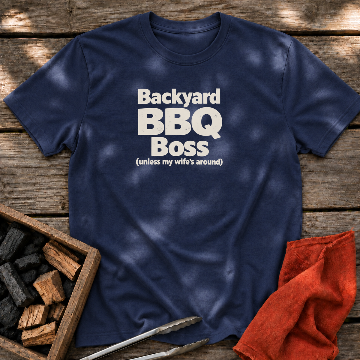 Navy T-shirt with the design “Backyard BBQ Boss (unless my wife's around)” printed on the front.