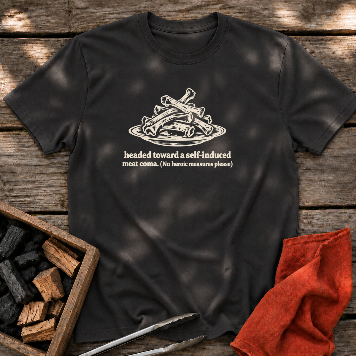 Black T-shirt with the design “headed toward a self-induced meat coma. (No heroic measures please)” printed on the front.