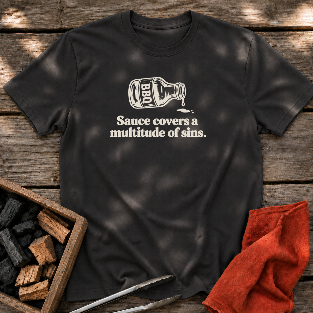 Black T-shirt with the design “Sauce covers a multitude of sins.” printed on the front.