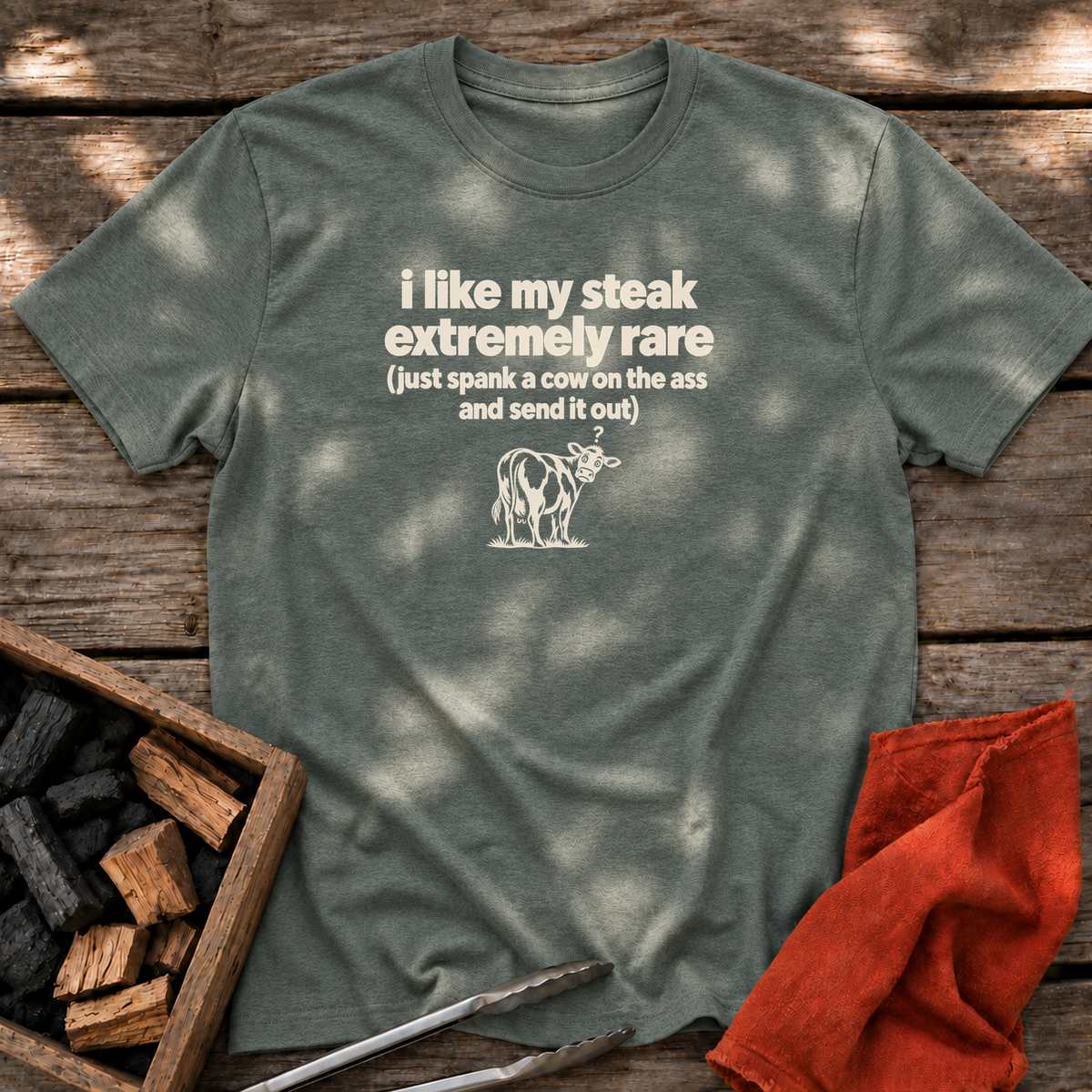 Heather Military Green T-shirt with the design “i like my steak extremely rare (just spank a cow on the ass and send it out)” printed on the front.
