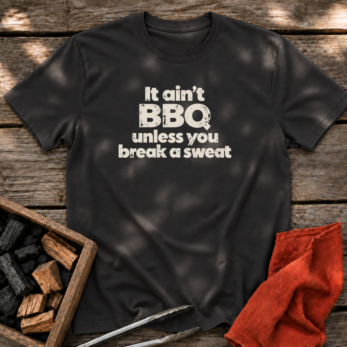 Black T-shirt with the design “It ain't BBQ unless you break a sweat” printed on the front.