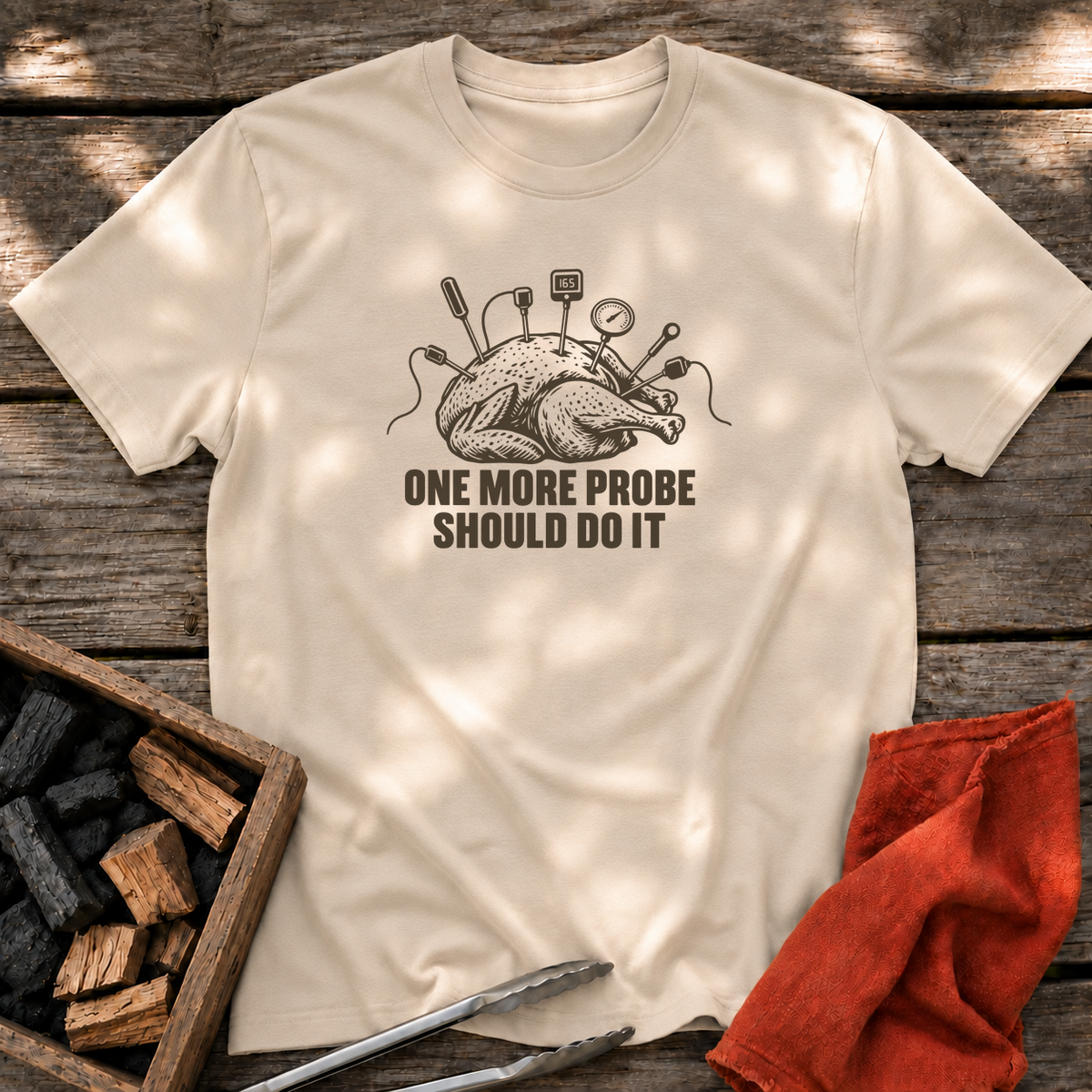 Sand T-shirt with the design “ONE MORE PROBE SHOULD DO IT” printed on the front.