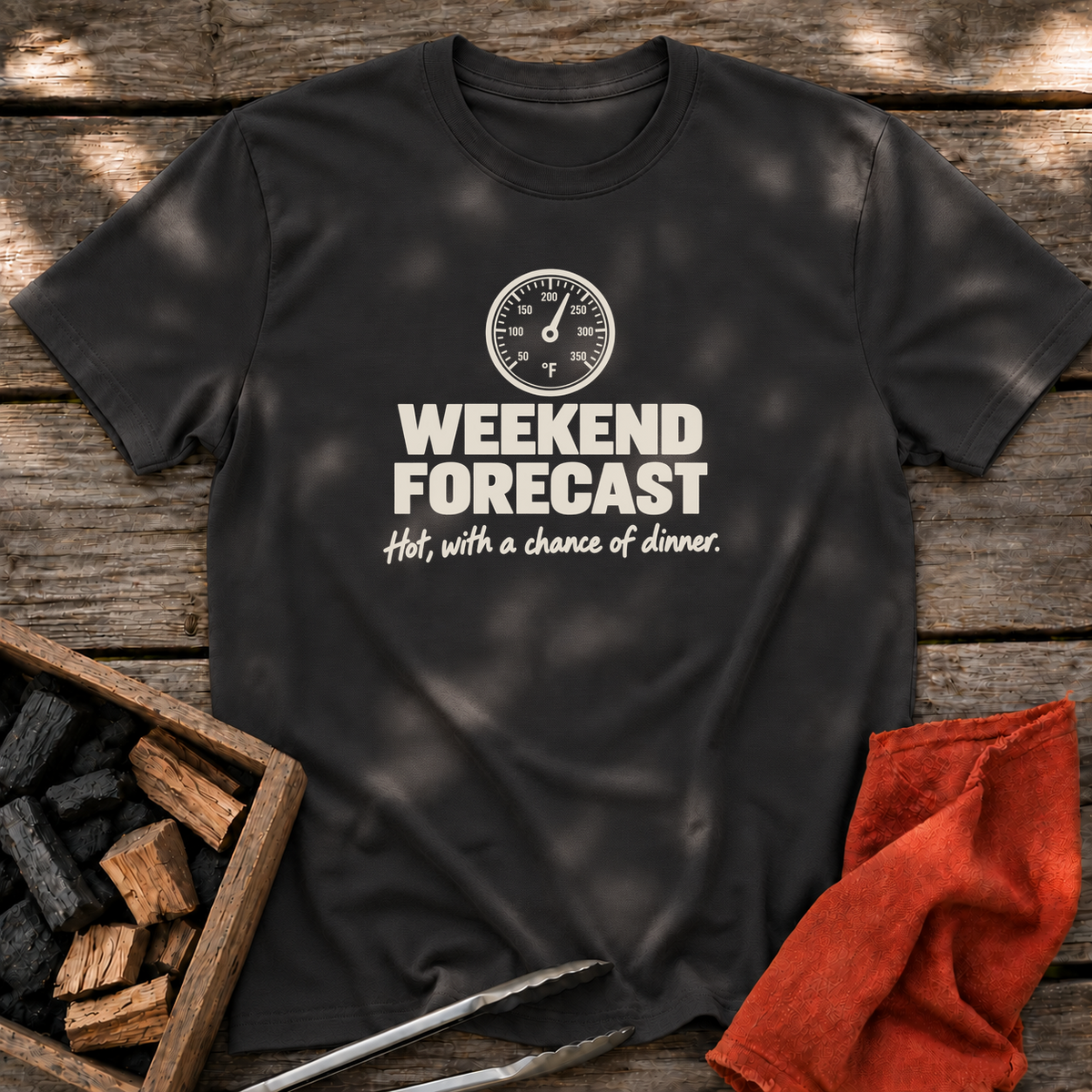 Black T-shirt with the design “Weekend forecast: Hot, with a chance of dinner.” printed on the front.