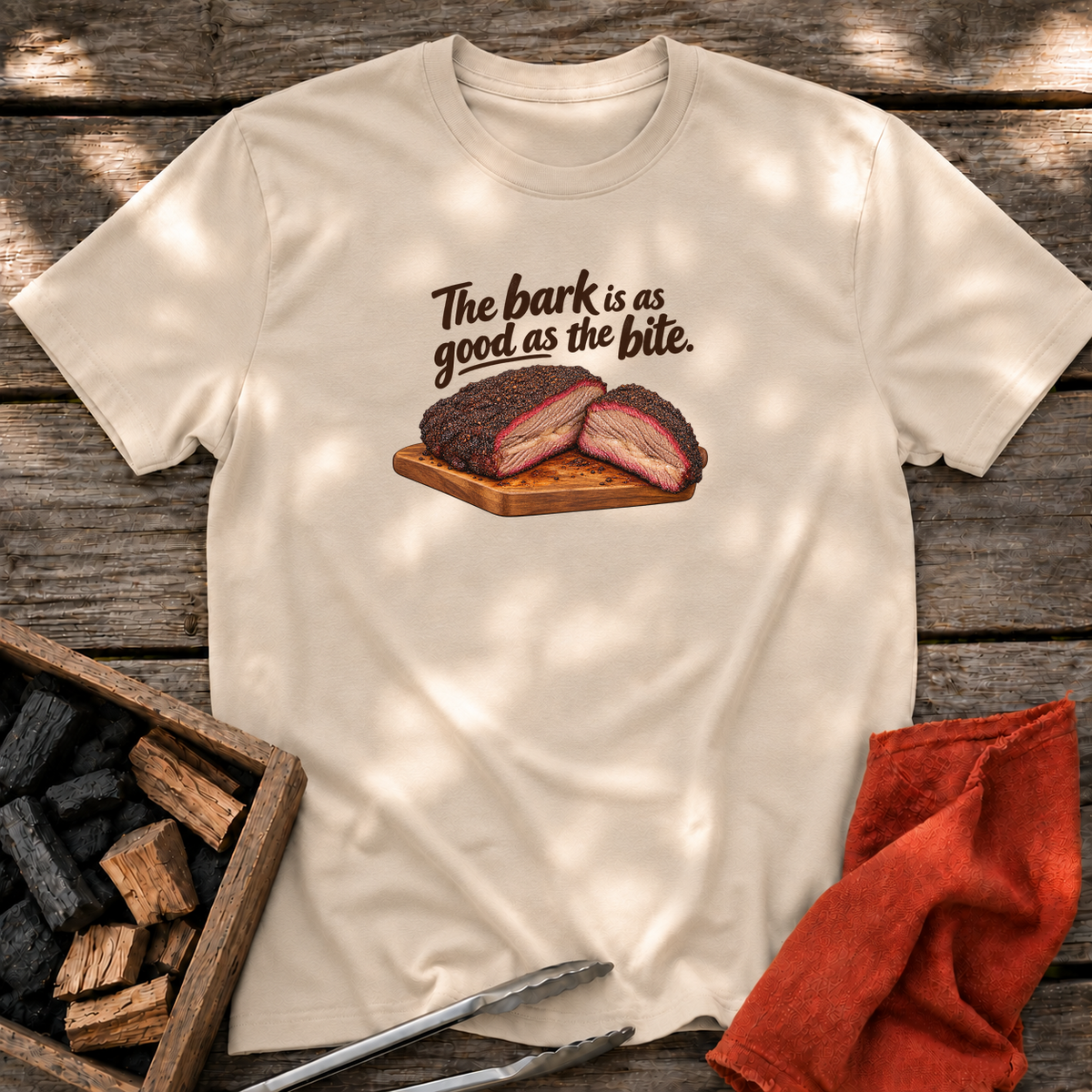 Sand T-shirt with the design “The bark is as good as the bite.” printed on the front.