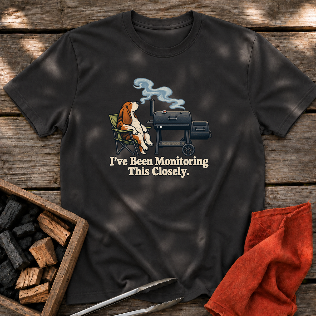 Black T-shirt with the design “I've Been Monitoring This Closely.” printed on the front.