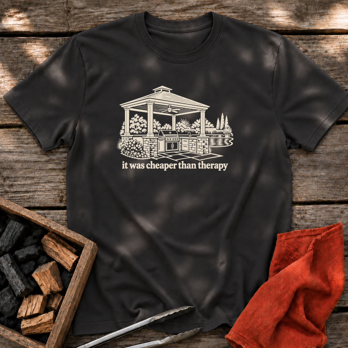 Black T-shirt with the design “it was cheaper than therapy” printed on the front.